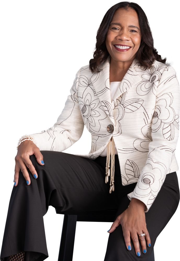Angela Pitter, founder and CEO of LiveWire Collaborative, seated, wearing a cream floral jacket